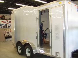 Side door entry allows easy access to Graco H-25 spray foam proportioning unit and spray foam equipment.